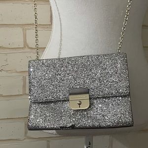 Kate spade squint purse with silver detailing.